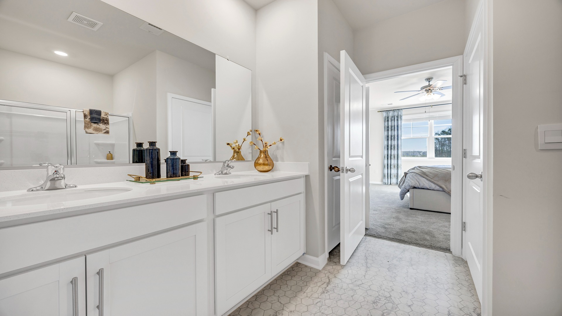 Double primary vanity in new construction home with white quartz countertops