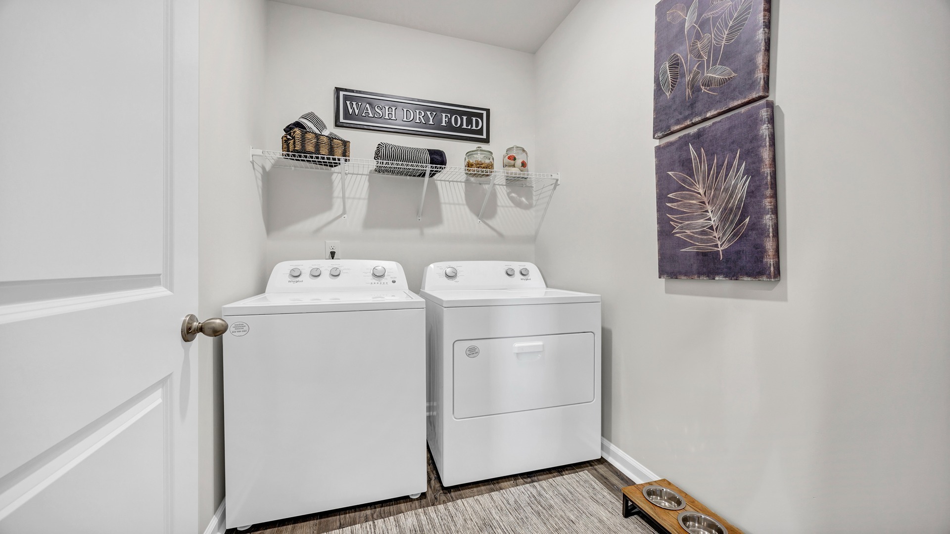 Laundry room downstairs in home for sale with matching washer and dryer