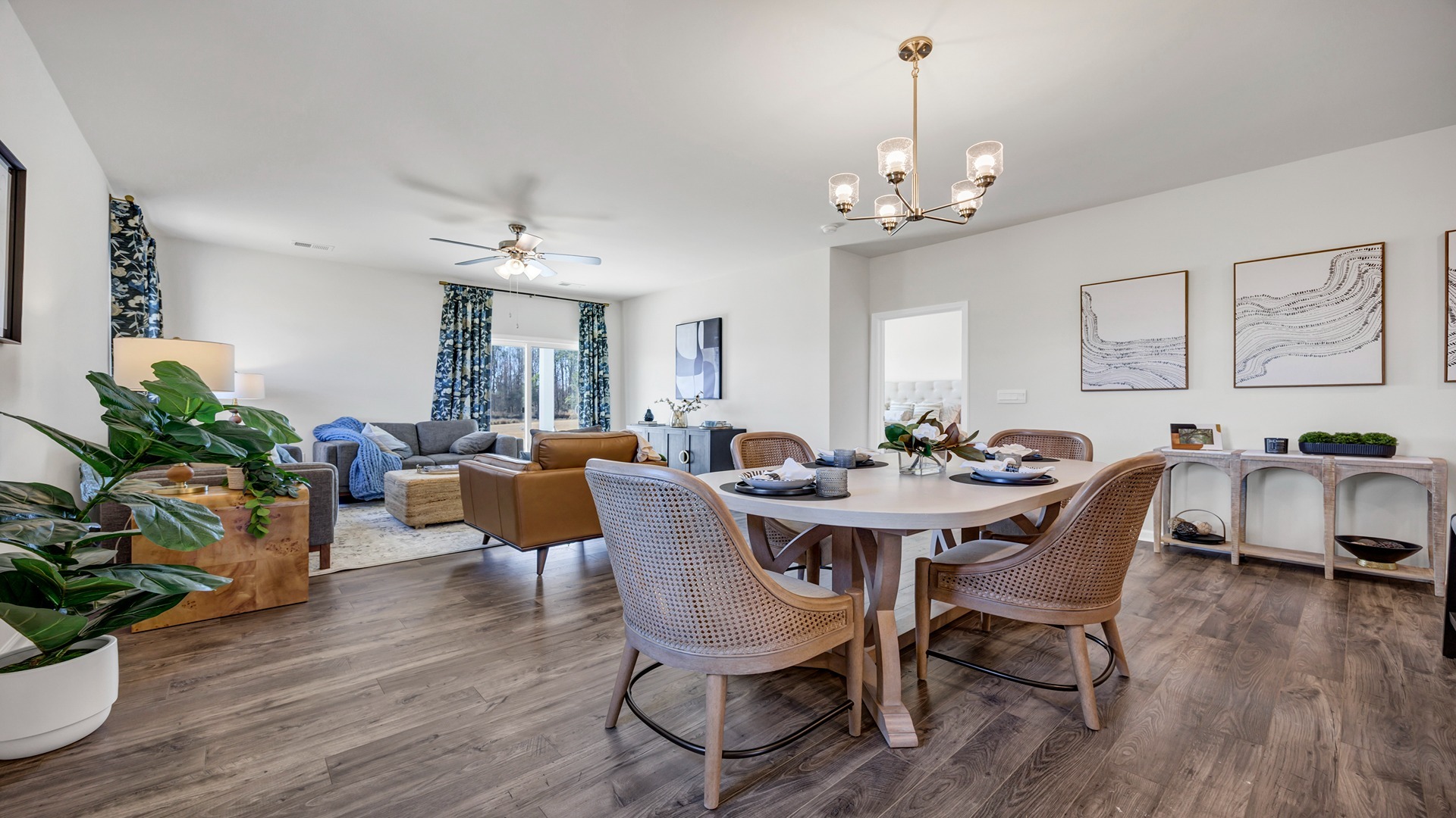 Open concept dining and living areas finished with matching RevWood floors