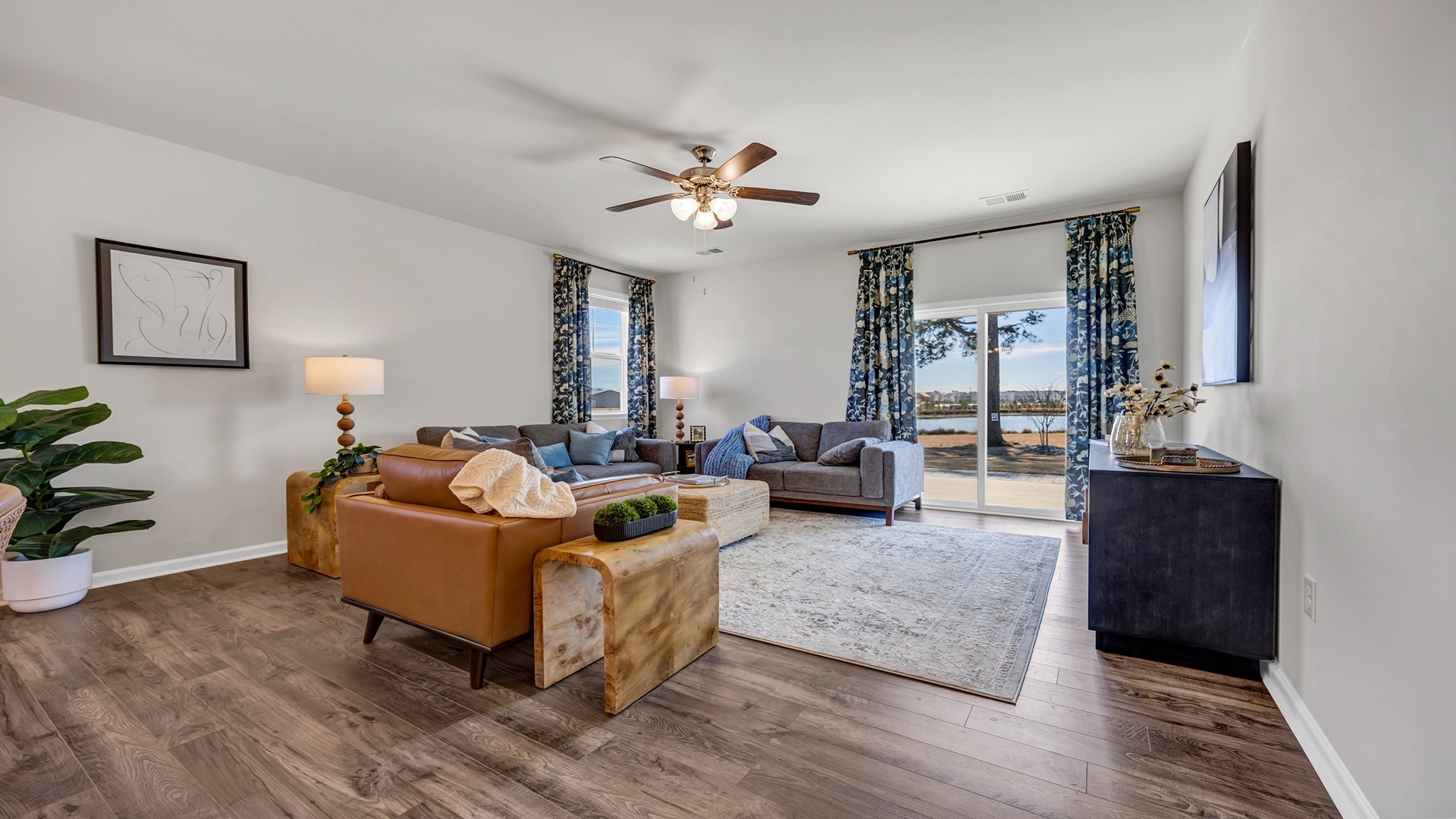 Living area in new construction home with RevWood floors and neutral walls