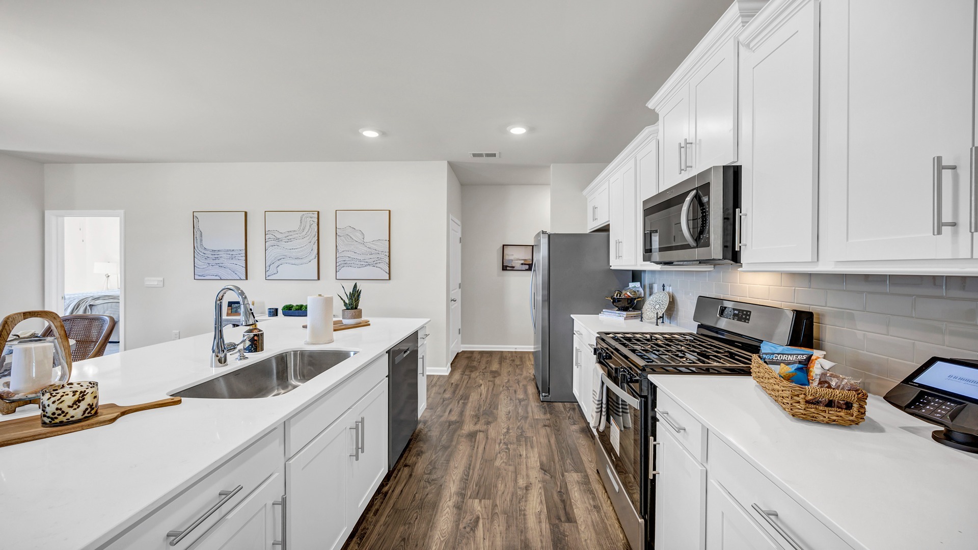 Tile backsplash and white quartz countertops complete the new construction kitchen space