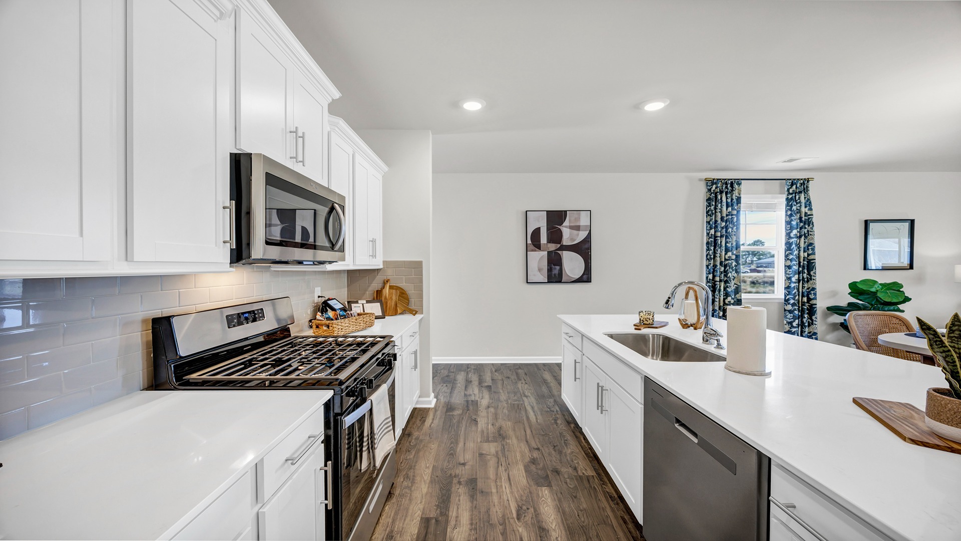 White cabinets finish the modern kitchen in the new construction home for sale in Sease's Pond