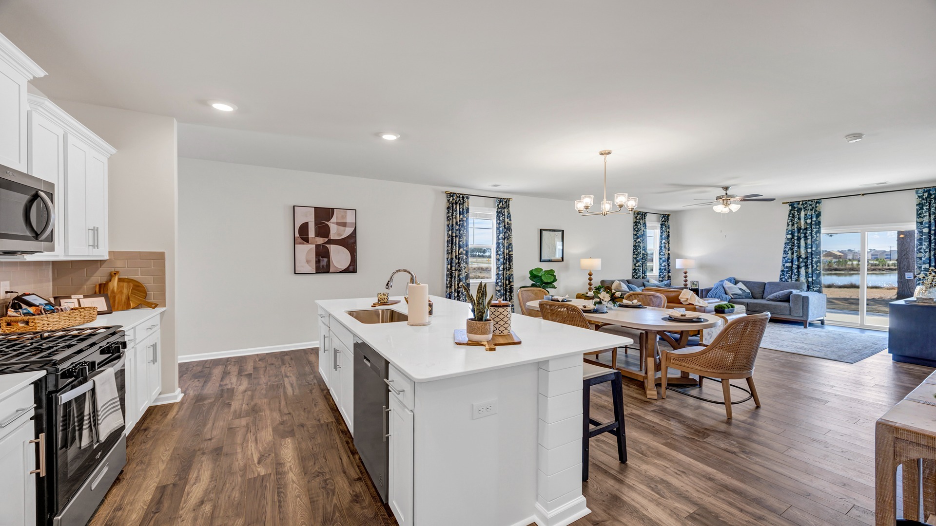 Floating kitchen island overlooks the open concept dining and living areas