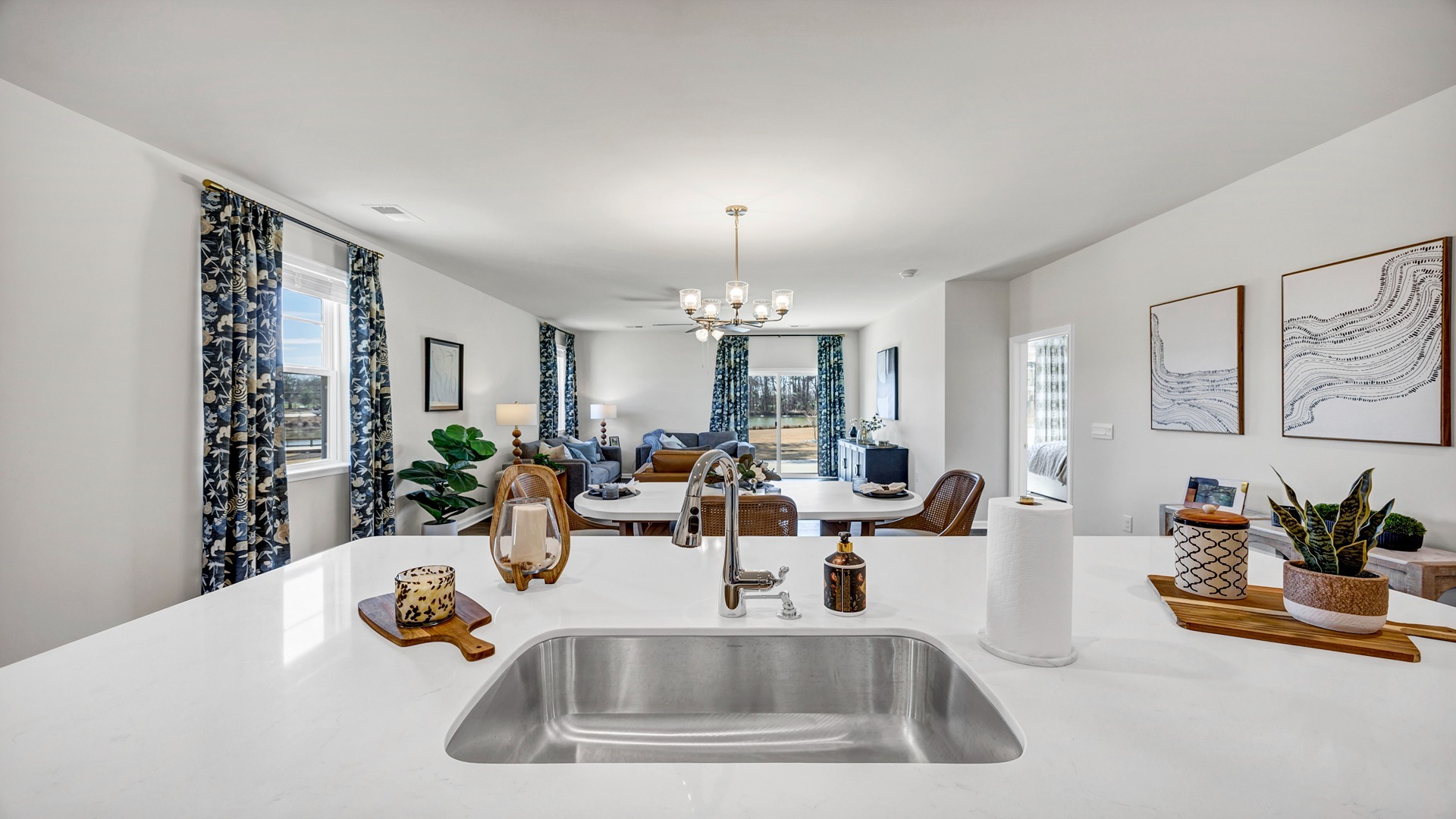 Kitchen sink on island overlooks the dining and living areas