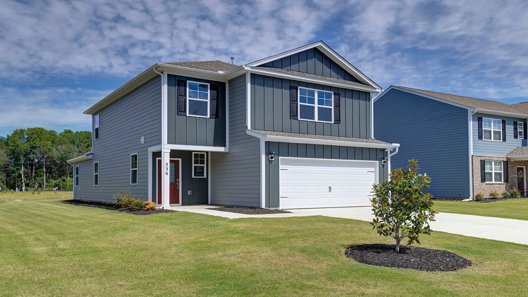 The Manning in Sease's Pond with dark gray Hardie Plank siding.