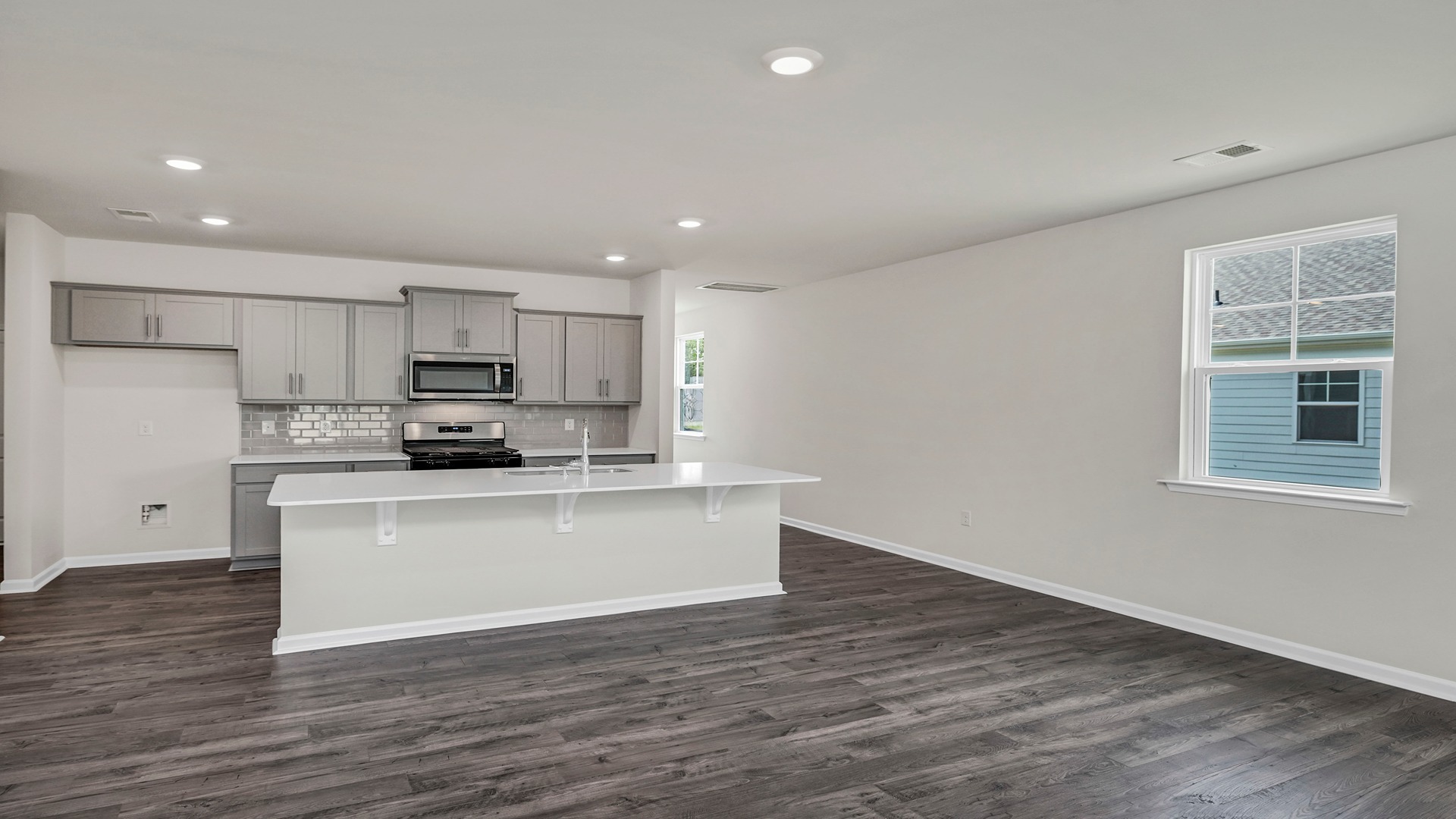 The floating kitchen island features space for barstool seating