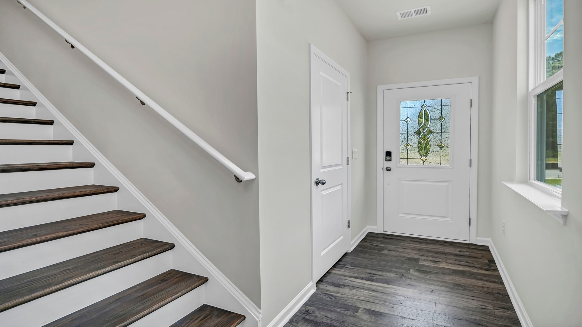 Stairway to upstairs off the front foyer