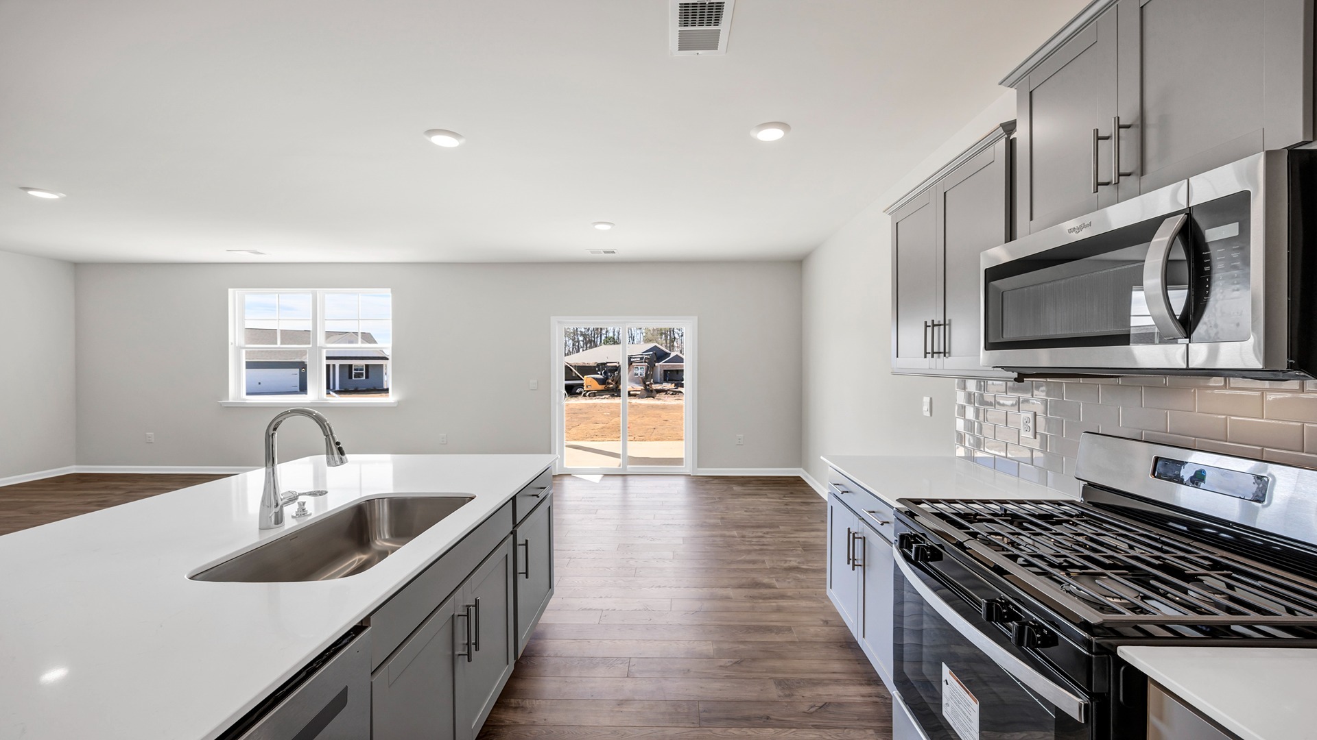 Gray cabinetry and white quartz countertops in kitchen