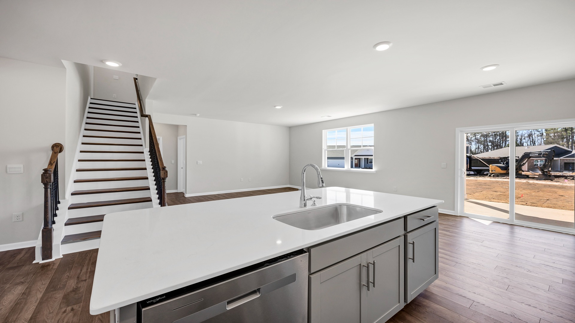 Kitchen sink on floating island overlooking dining and living areas