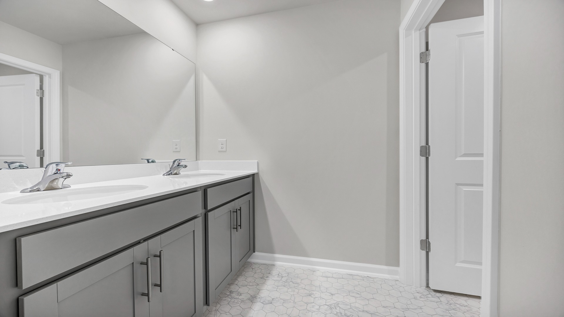 Bathroom 3 upstairs with gray cabinetry and a shower/tub combo