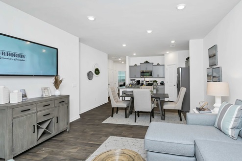 Open concept dining, living, and kitchen areas