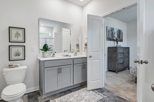 Primary bathroom featuring French doors and a double vanity