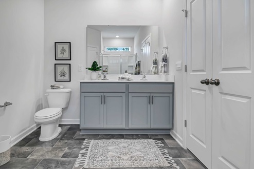 Primary bathroom with gray cabinetry