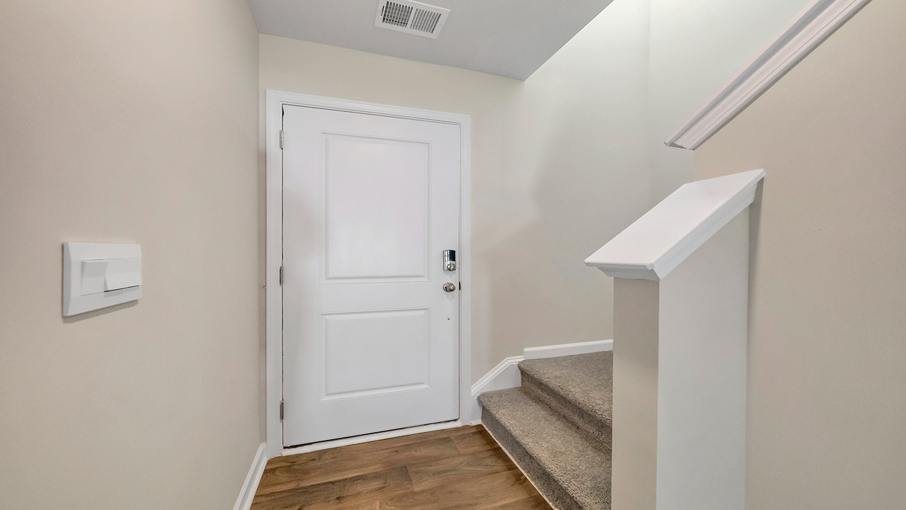 The front foyer leads to the stairway to upstairs.