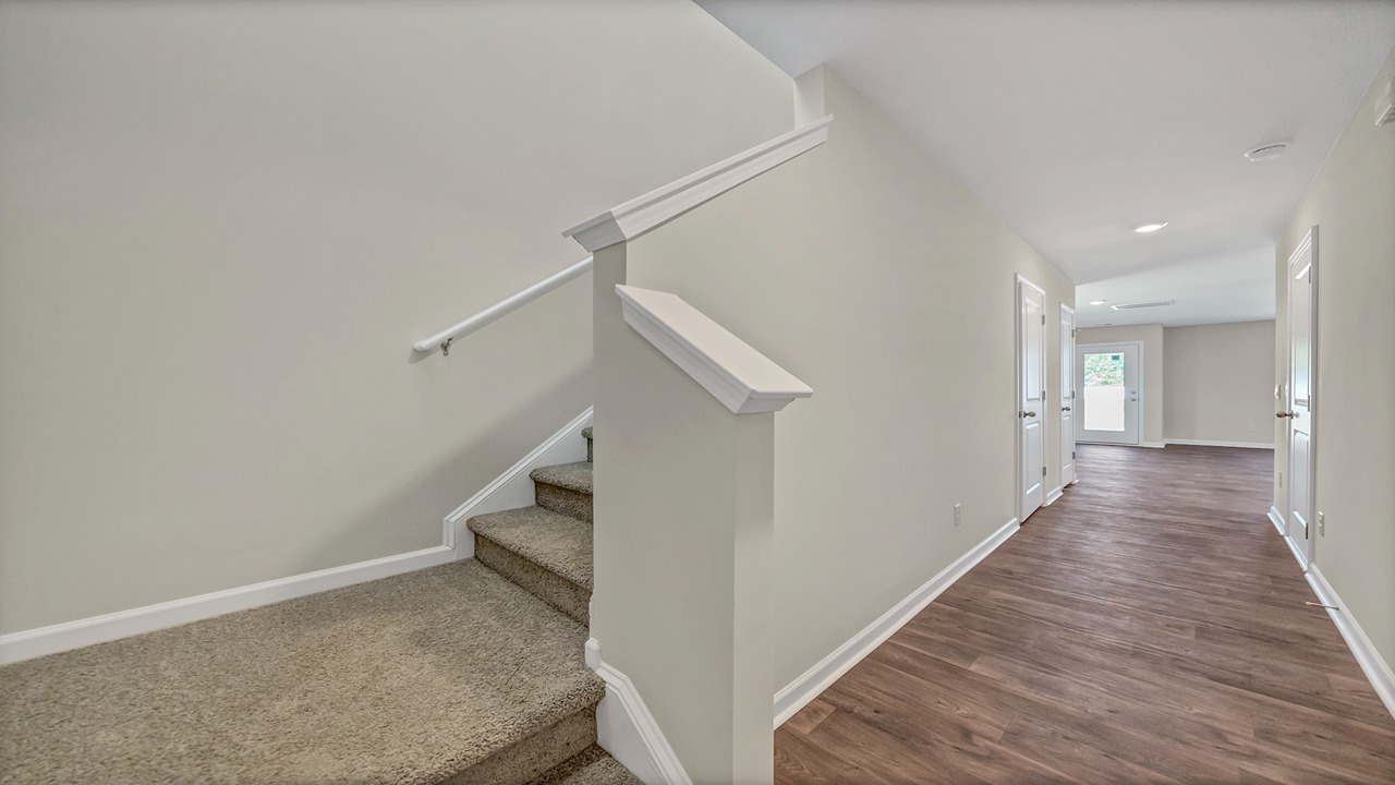 The front foyer leads to the stairway to upstairs.