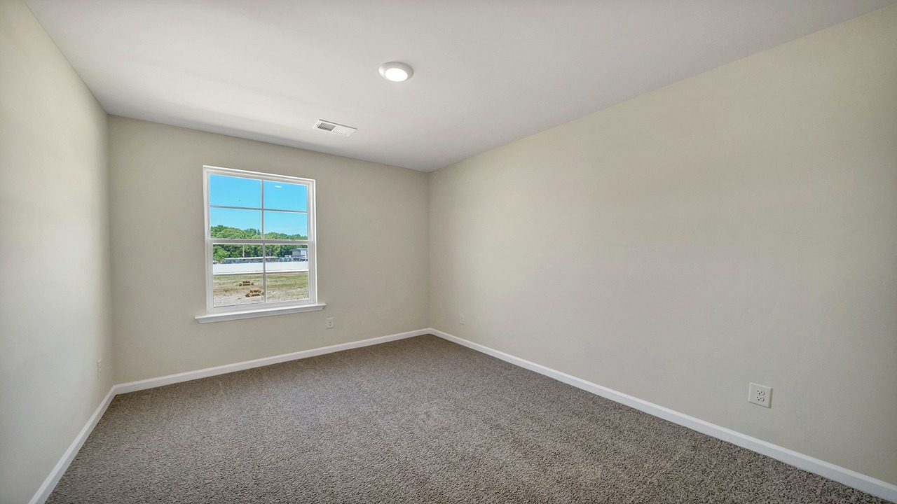 Bedroom 3 upstairs features a window and carpet flooring.