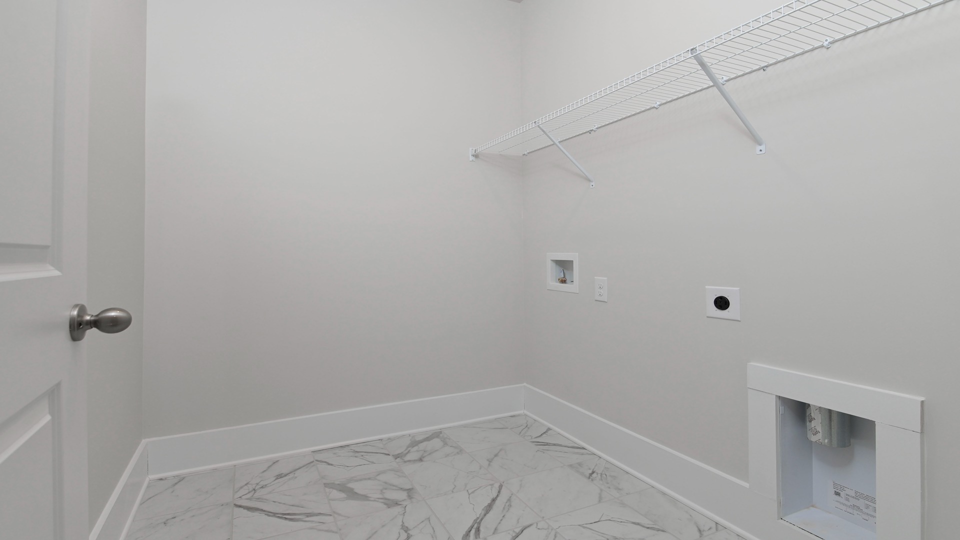 Landry room with wire shelving and tile flooring in available home in Lake Tide Summit