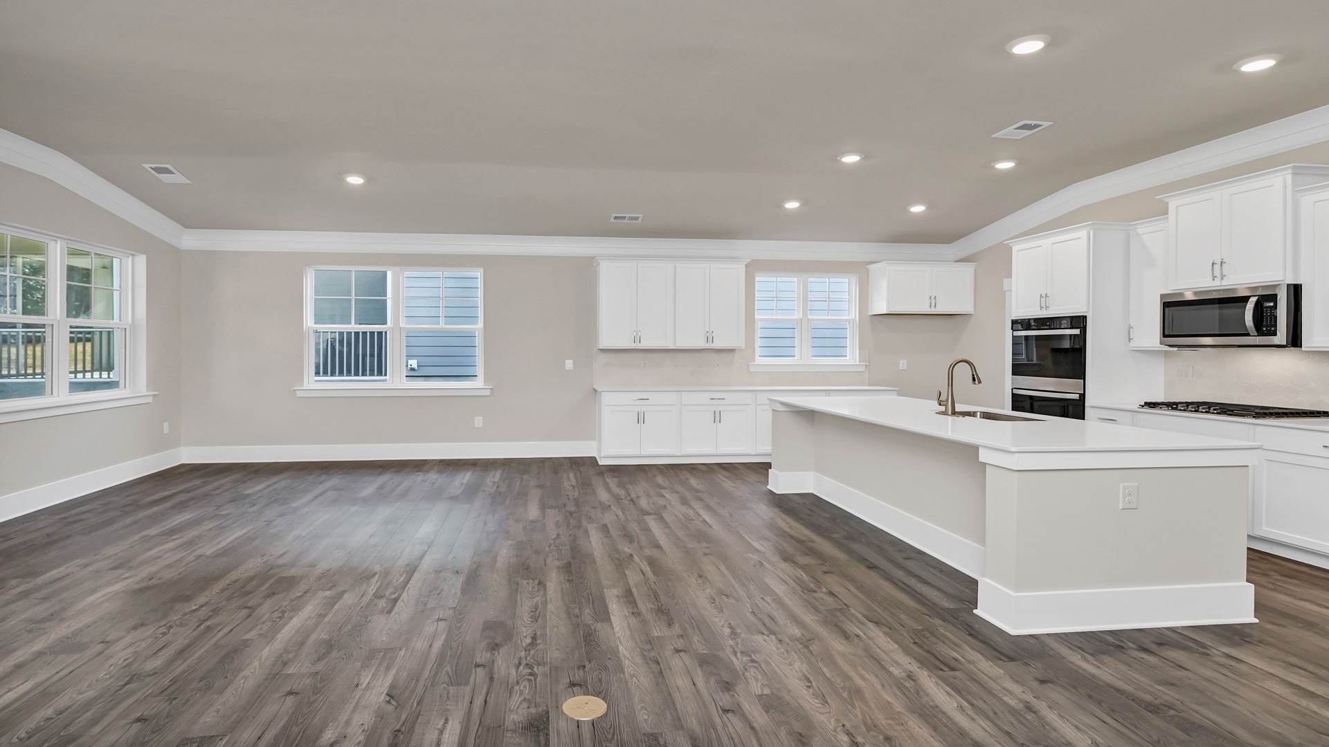 White cabinets in kitchen and kitchen flowing seamlessly into dining space