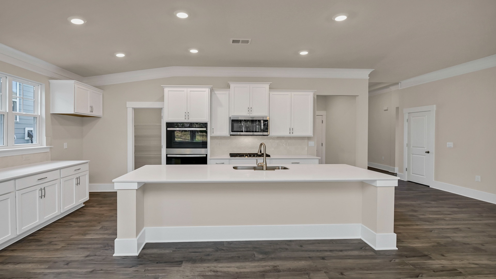 Kitchen in new construction home with a large floating island