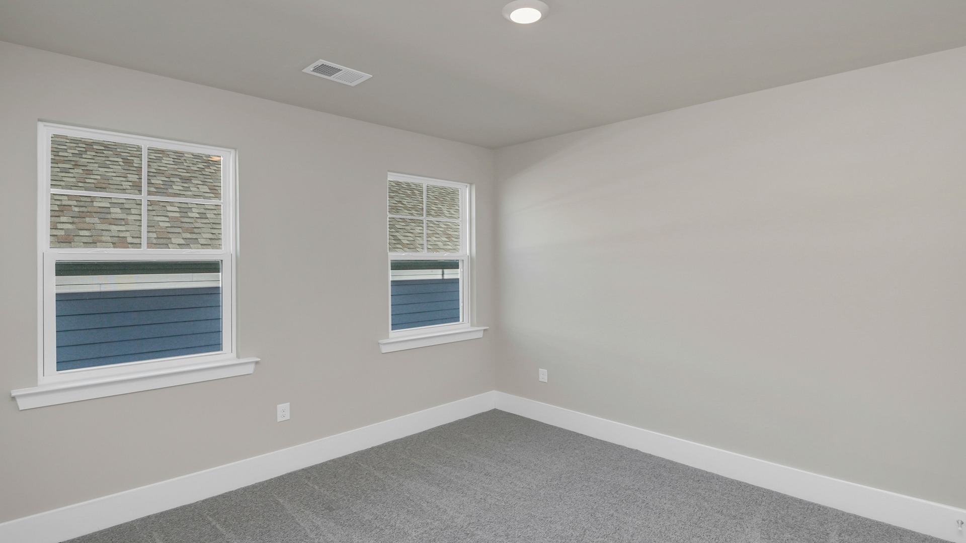 Bedroom 3 with carpet flooring and 2 side-facing windows