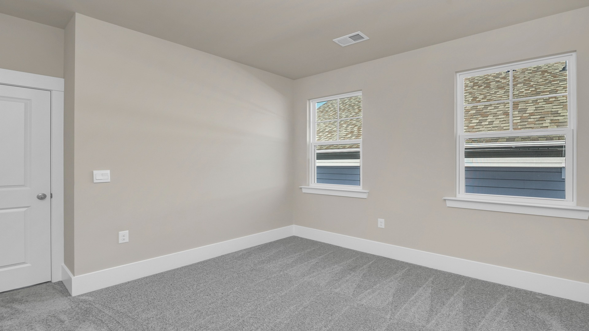 Carpet flooring and neutral-painted walls in bedroom 3