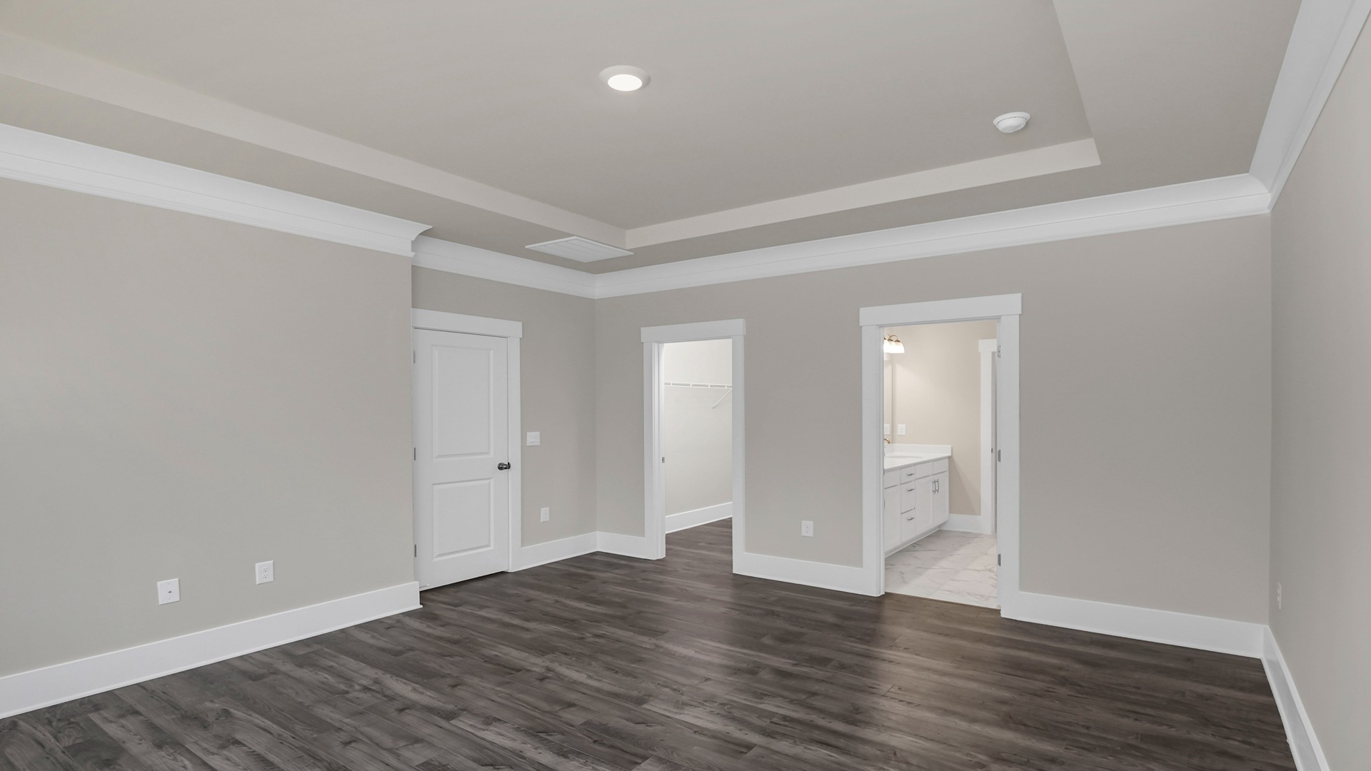 Revwood flooring and tray ceilings in the primary bedroom