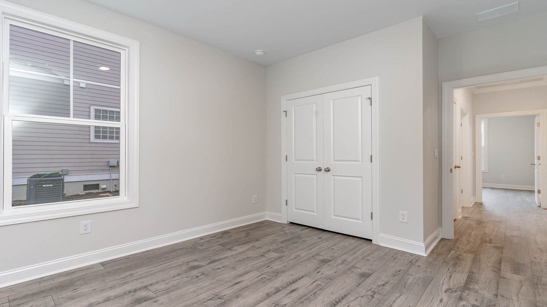 Bedroom 4 with a windwo for light and French closet doors