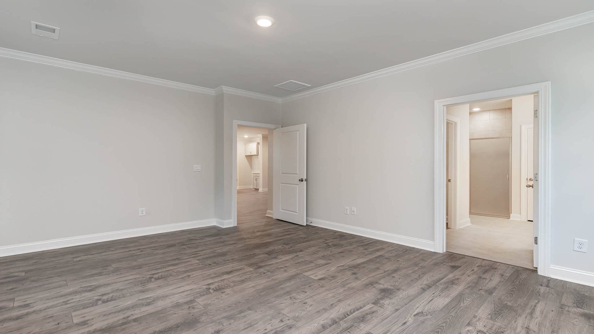 Spacious primary bedroom in ranch-style new home for sale in Chapin, SC