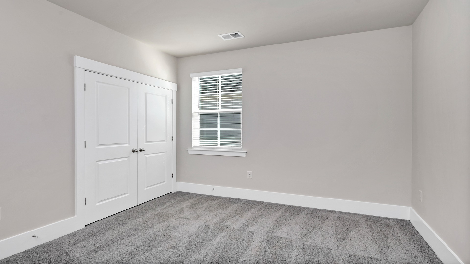 Bedroom 4 with a window and French closet doors