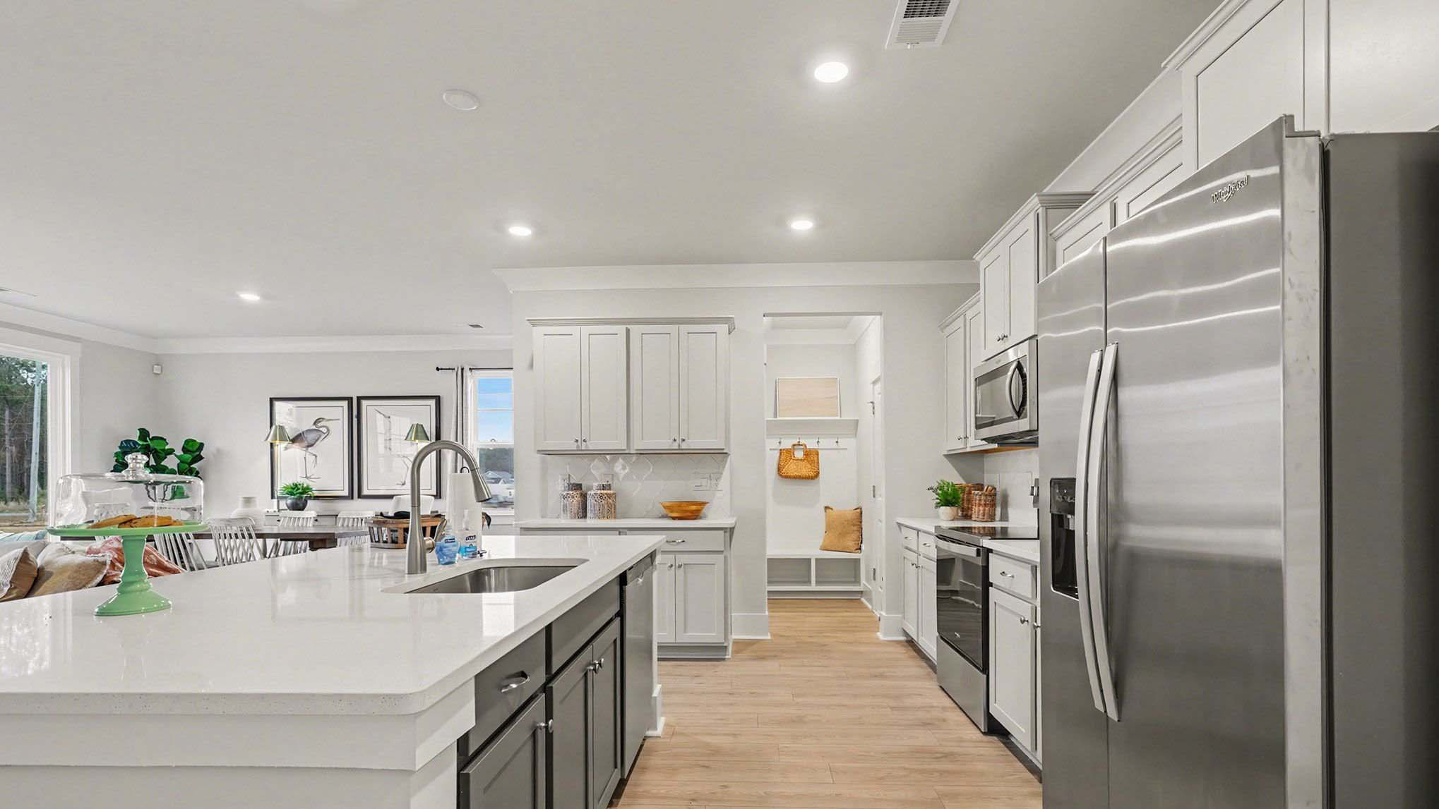 Spacious kitchen area in the Belfort with modern, sleek white quartz countertops