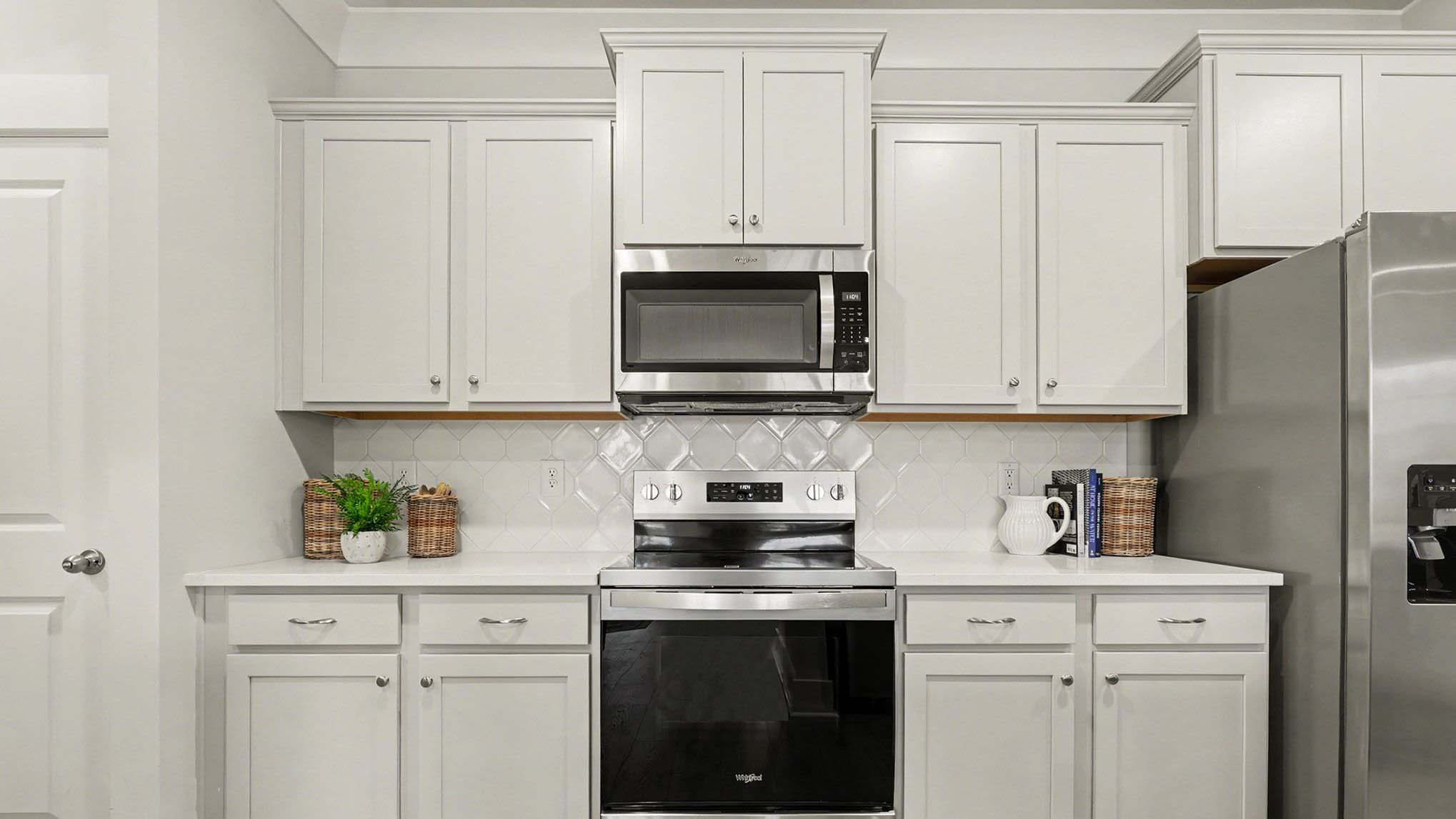 Tile backsplash and stainless-steel appliances finish the kitchen space