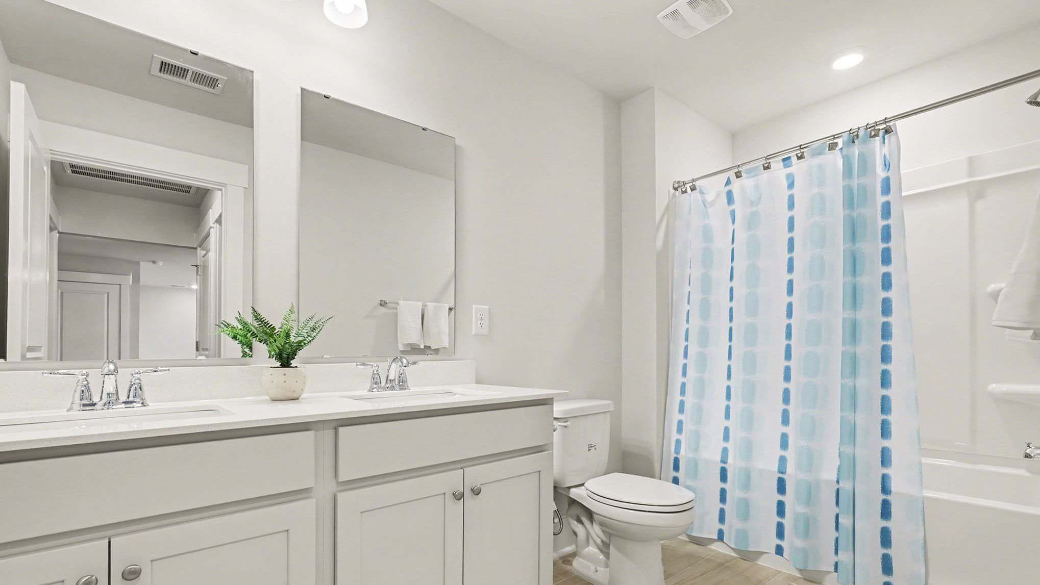 Bathroom 2 upstairs in the Belfort with a shower tub combo and dual vanity