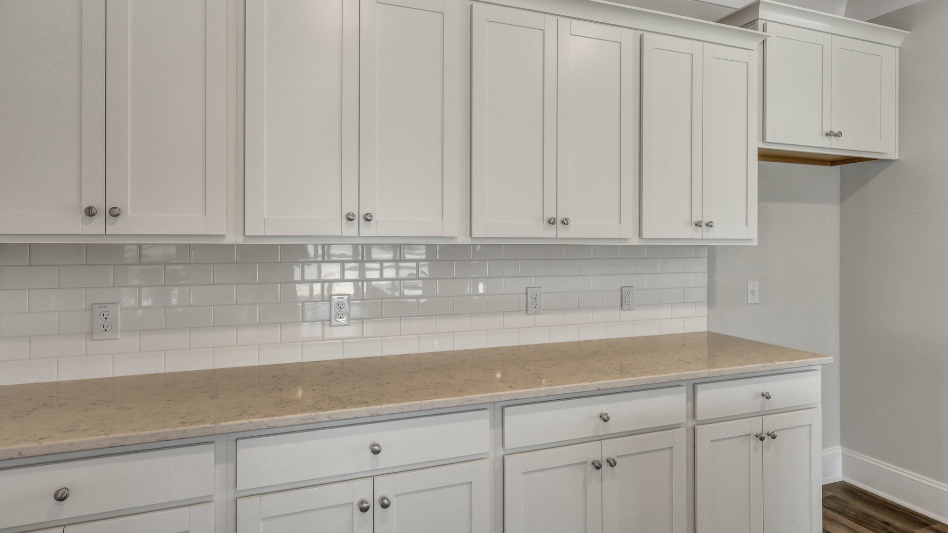 Extra counter and cabinet space in the kitchen area along the wall
