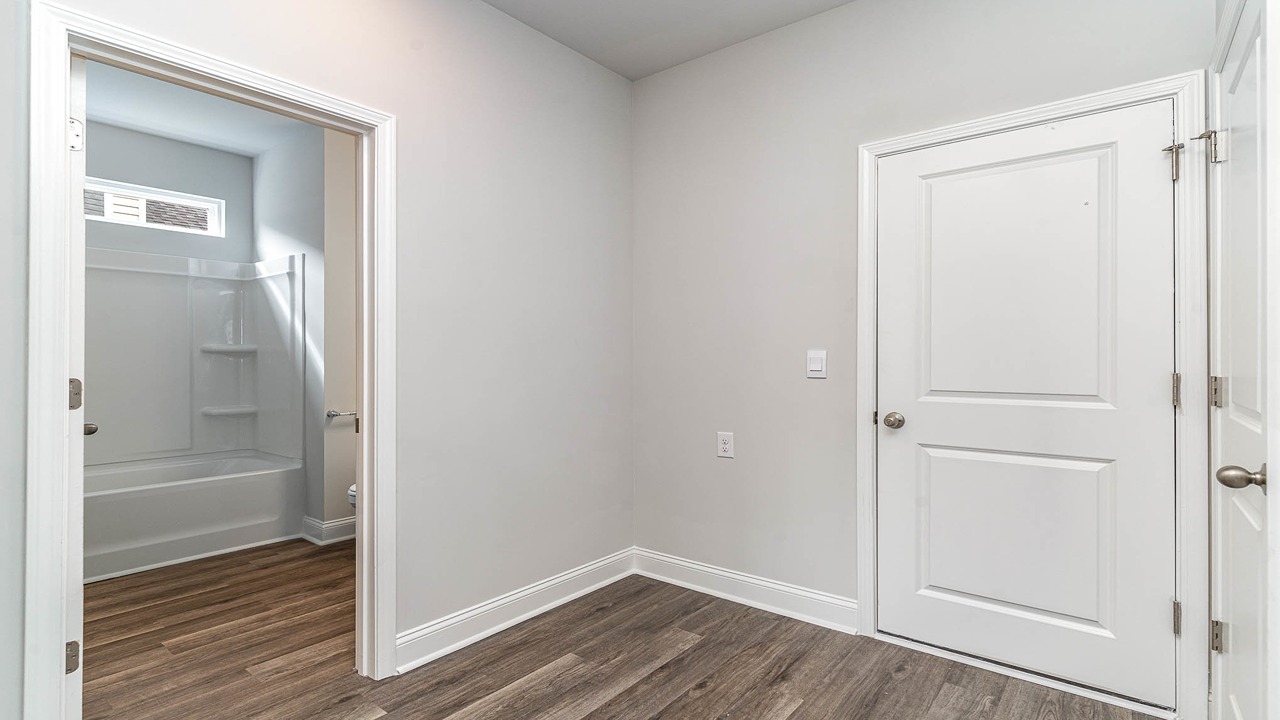Hallway for bedroom 4 and bathroom 2 with access to garage entry