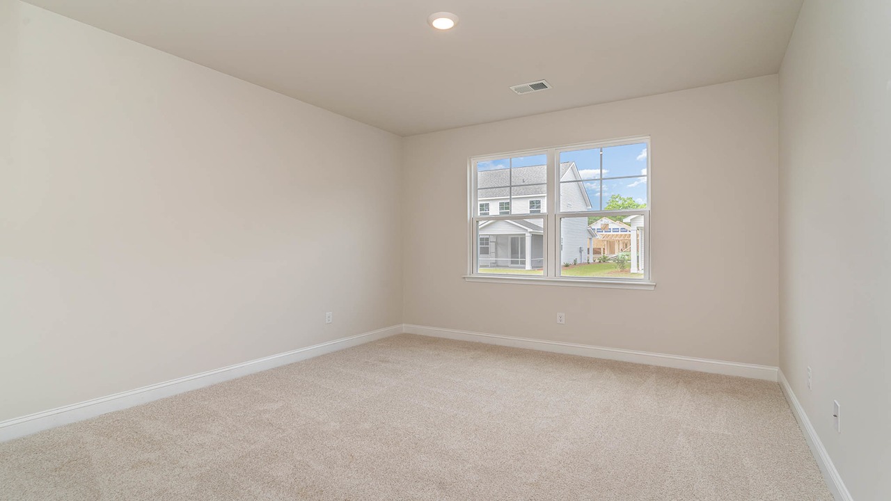 Bedroom 4 downstairs with a large window for natural light