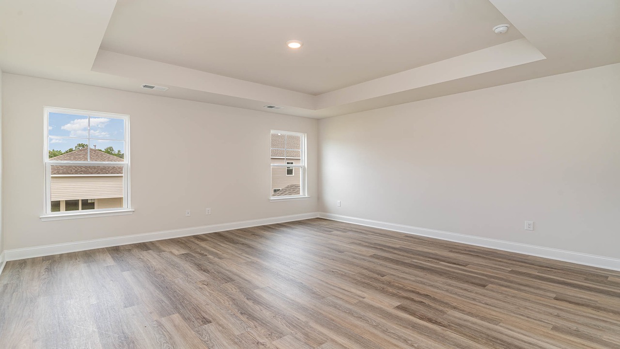 Primary bedroom upstairs with 2 large windows