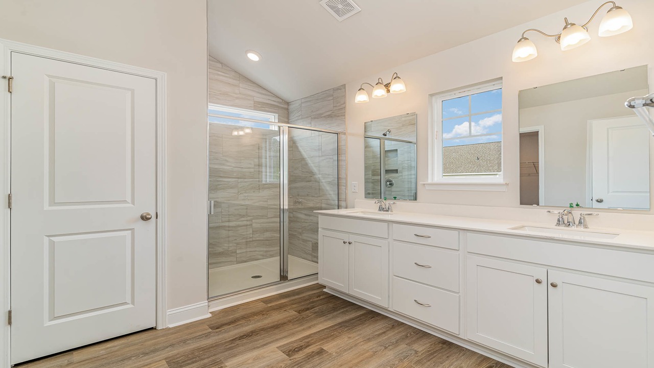 Double vanity and standup shower in the primary bathroom