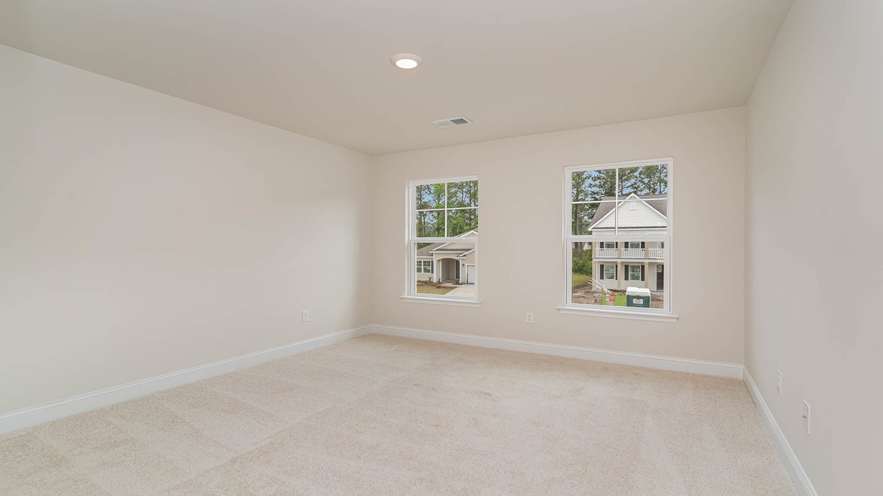 Bedroom 2 upstairs with 2 windows and carpet flooring