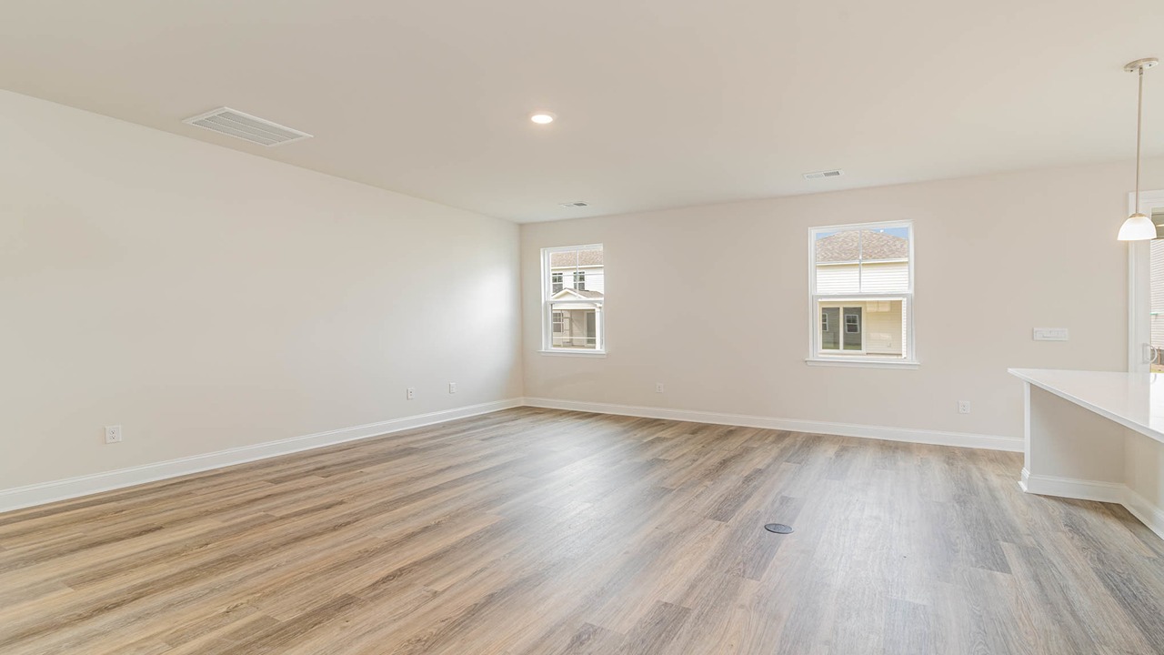 Living area with RevWood floors and windows for light