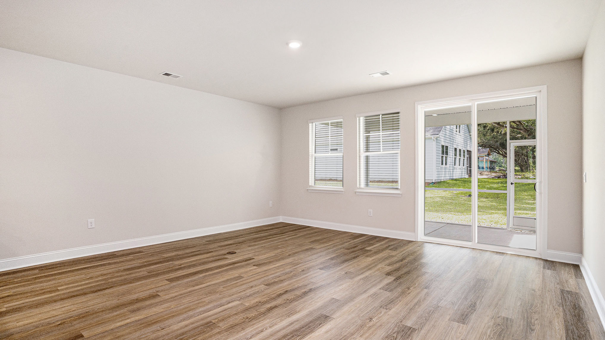 Sliding glass doors in the living area leads to the paved screened-in back patio