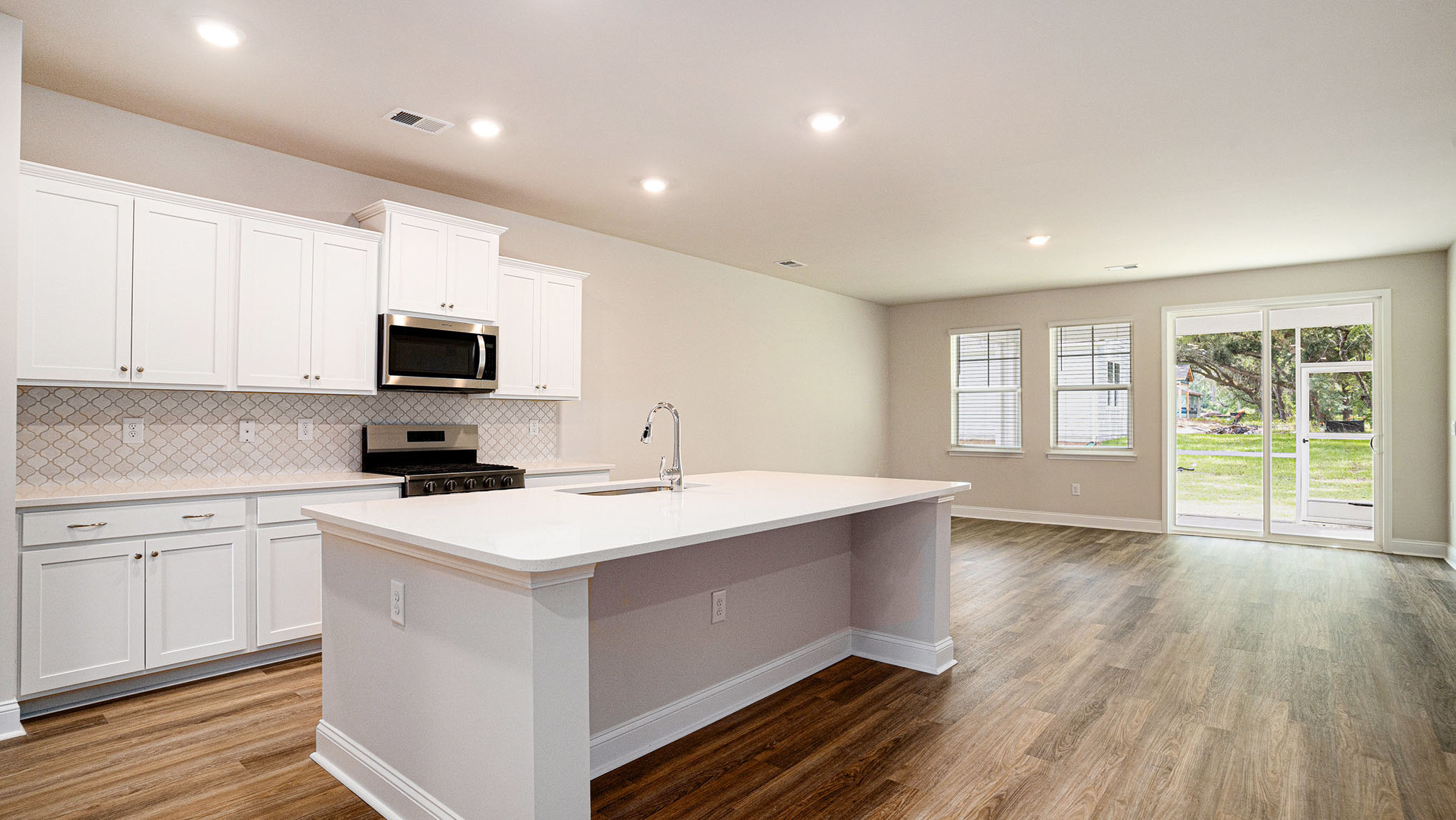 Open concept kitchen and living areas in home for sale in Chapin, SC