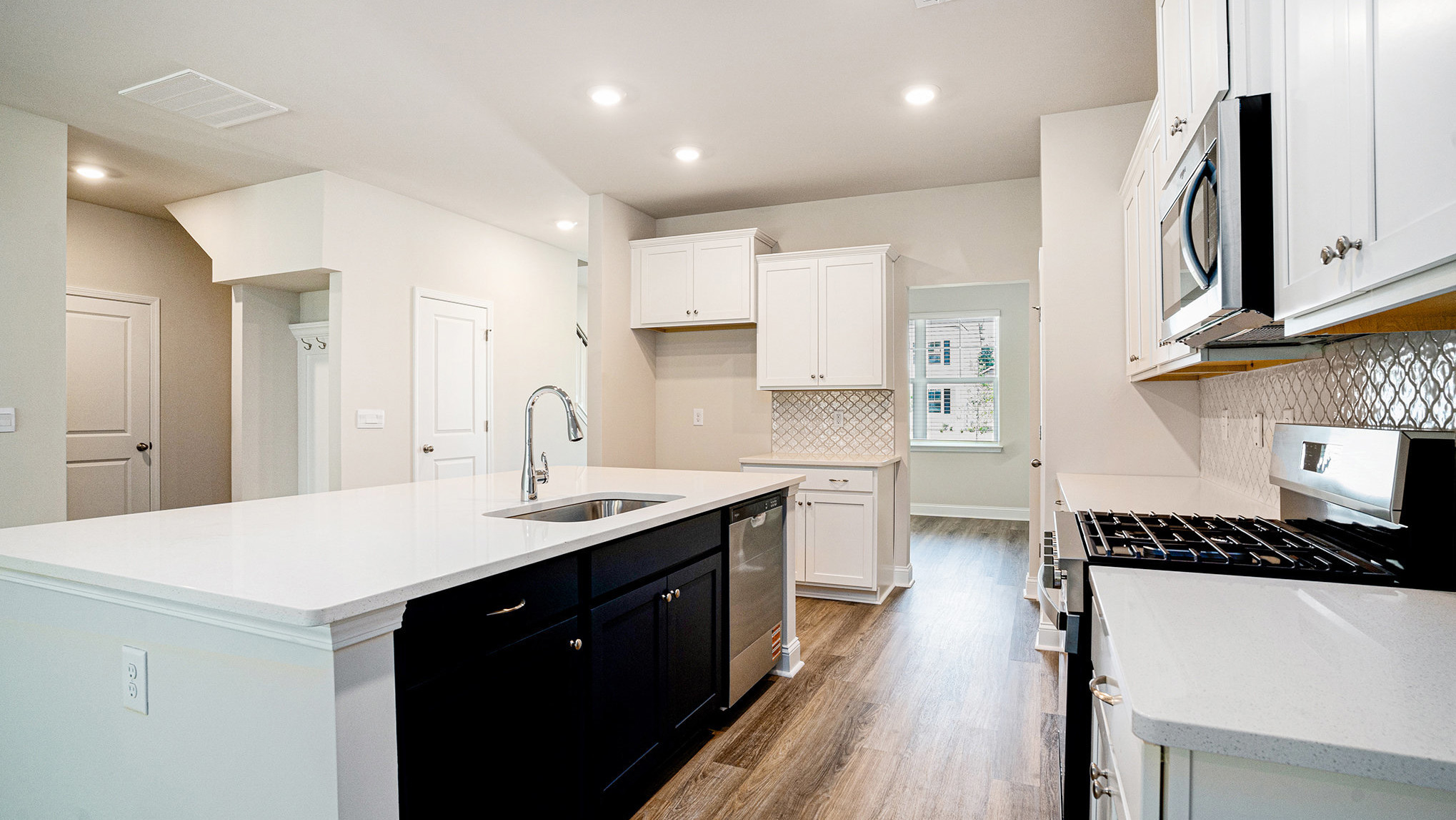 Sleek white quartz countertops in the spacious kitchen in home for sale near Lake Murray