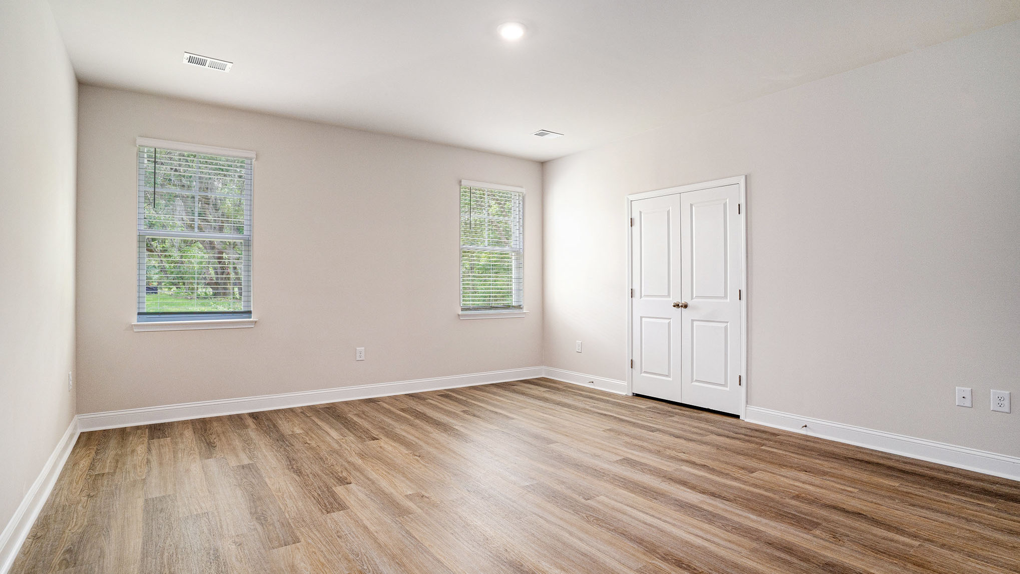 Downstairs primary bedroom with 2 large windows for natural light