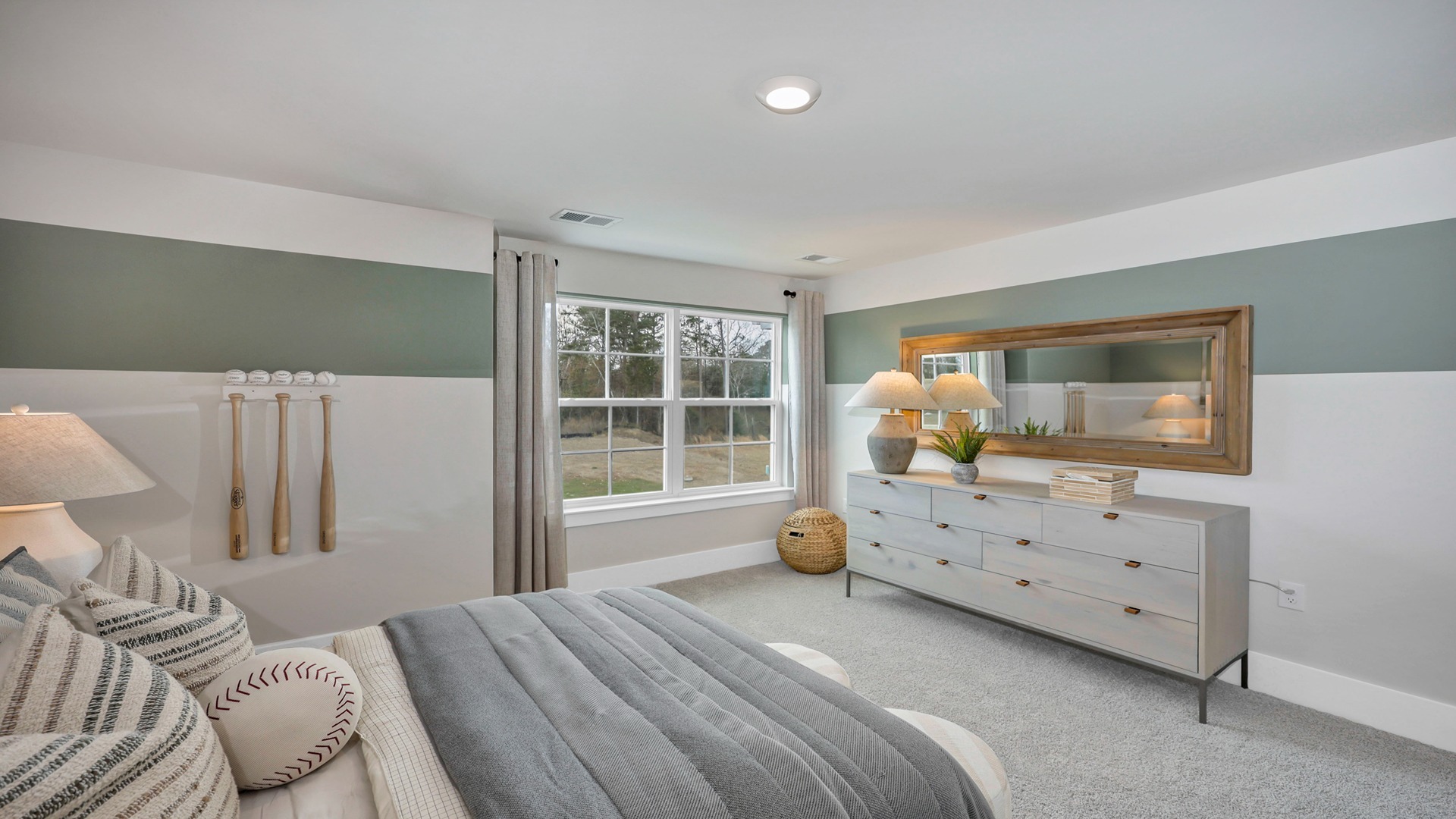 Bedroom 2 upstairs with a large front facing window and carpet flooring