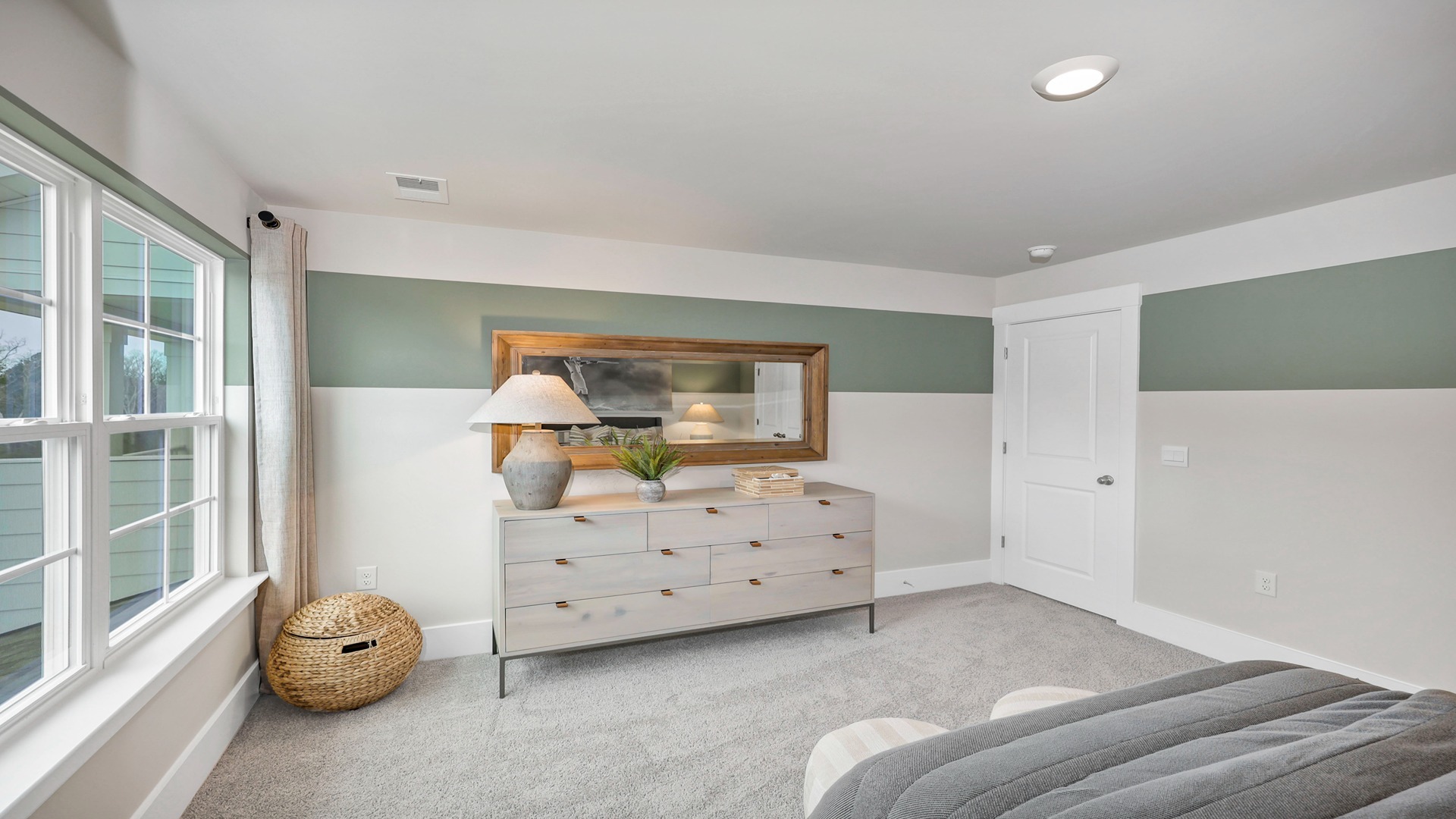 Bedroom 2 upstairs with a large window and carpet flooring