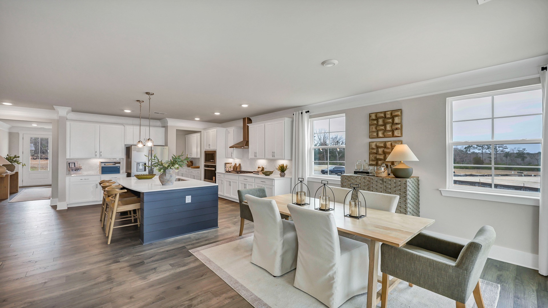 Open concept dining and kitchen areas with natural light