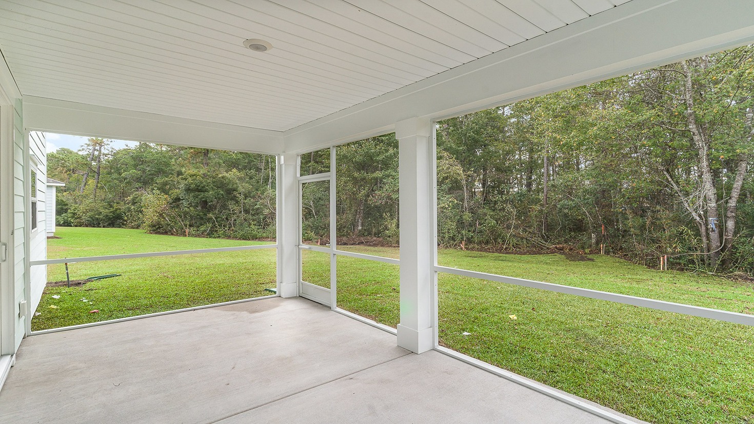 Paved back patio with the option to be screened-in