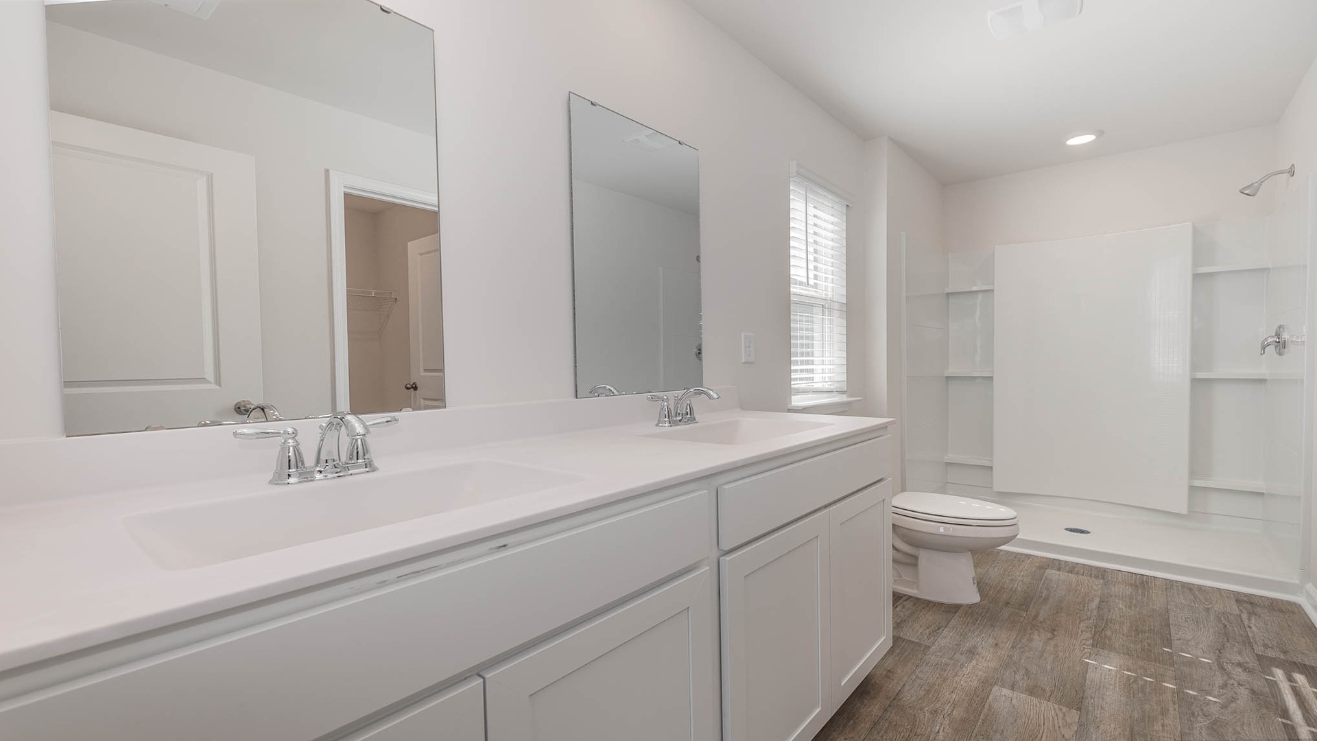 The primary bathroom features a double vanity and standup shower.