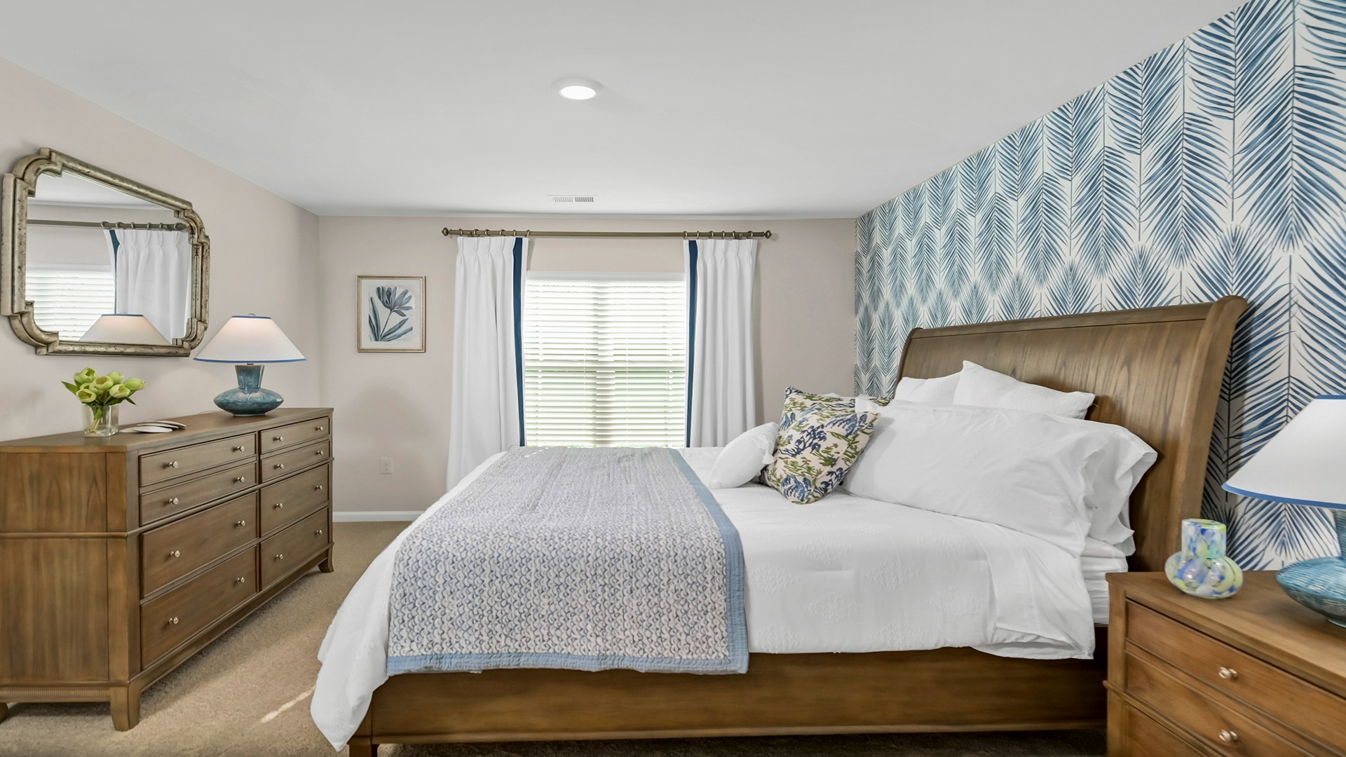 Primary bedroom with carpet flooring and a large window for light