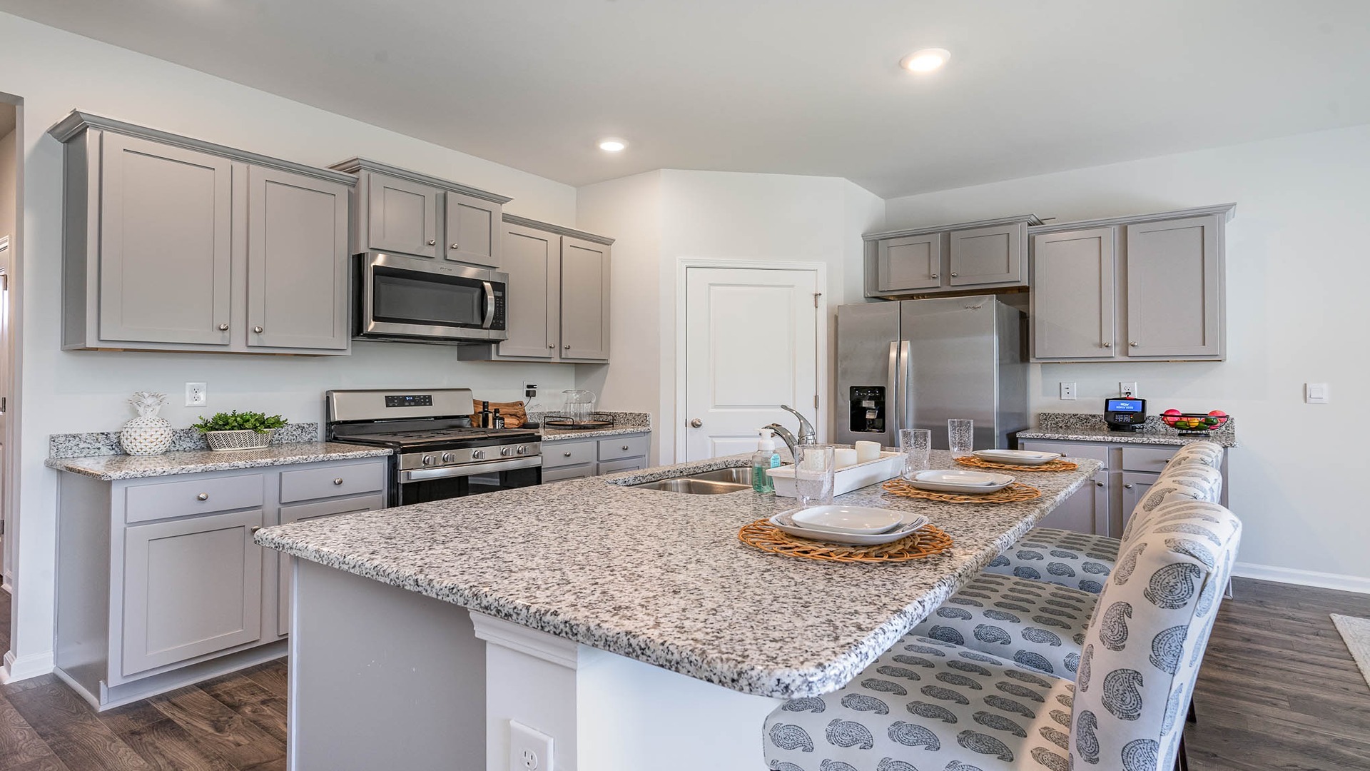 Gray cabinetry and granite countertops in the kitchen
